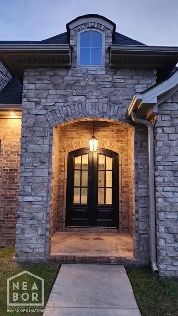 doorway to property with french doors and stone siding