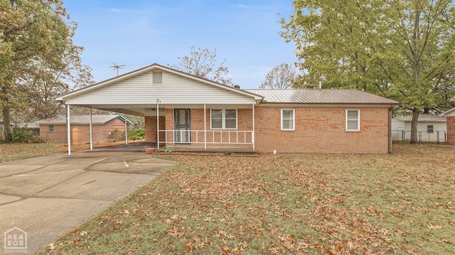 319 Stephans Ln, Corning, AR 72422 - ranch-style house with a porch, brick siding, fence, and driveway