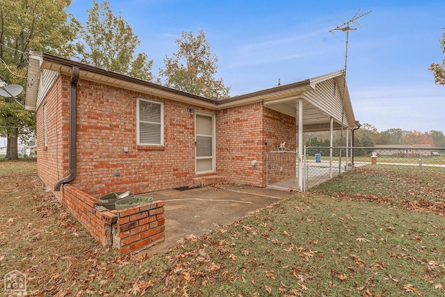 319 Stephans Ln, Corning, AR 72422 - rear view of house with brick siding and a patio area