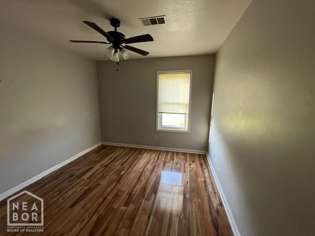1213 Pauline St, Trumann, AR 72472 - spare room with wood finished floors and a ceiling fan