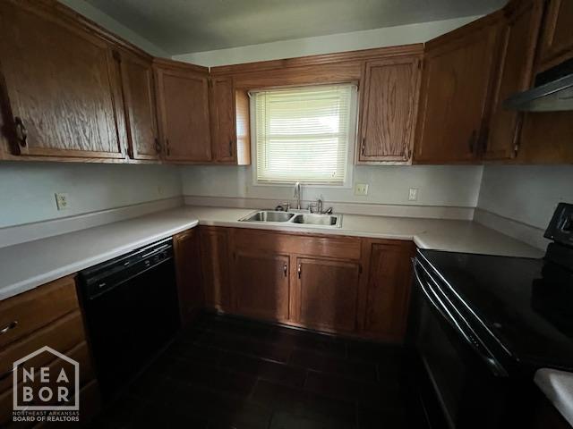 1213 Pauline St, Trumann, AR 72472 - kitchen with black appliances, under cabinet range hood, brown cabinets, and light countertops