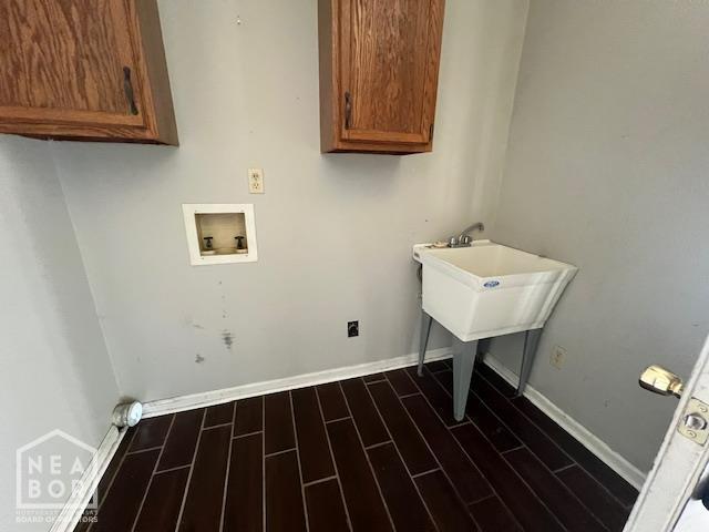 1213 Pauline St, Trumann, AR 72472 - laundry area with cabinet space, hookup for a washing machine, and dark wood finished floors