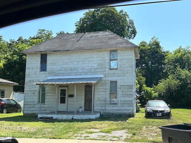 214 Miller St, Jonesboro, AR 72401 - view of front facade featuring covered porch and a front yard