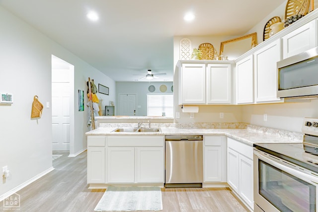 5405 Yukon Dr, Jonesboro, AR 72405 - kitchen with appliances with stainless steel finishes, light wood finished floors, white cabinets, light countertops, and ceiling fan