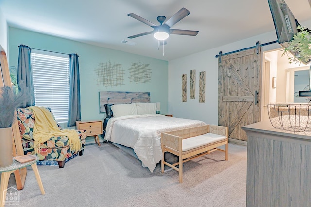 5405 Yukon Dr, Jonesboro, AR 72405 - carpeted bedroom with a barn door and a ceiling fan