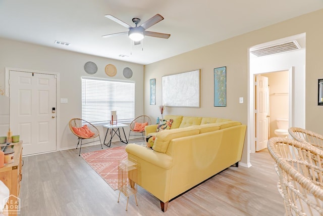 5405 Yukon Dr, Jonesboro, AR 72405 - living area with a ceiling fan and light wood-style floors
