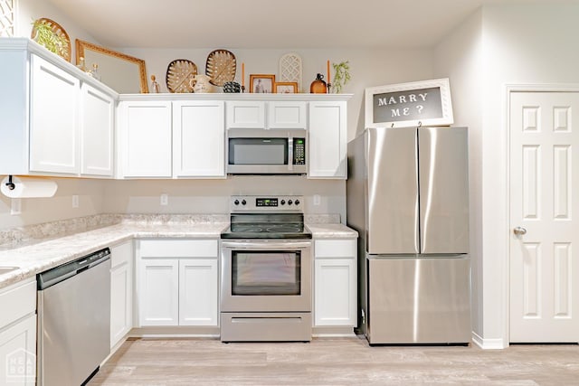 5405 Yukon Dr, Jonesboro, AR 72405 - kitchen featuring stainless steel appliances, white cabinetry, and light wood-type flooring