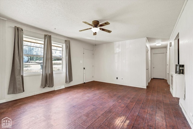 empty room with hardwood / wood-style floors, visible vents, a ceiling fan, baseboards, and a textured ceiling