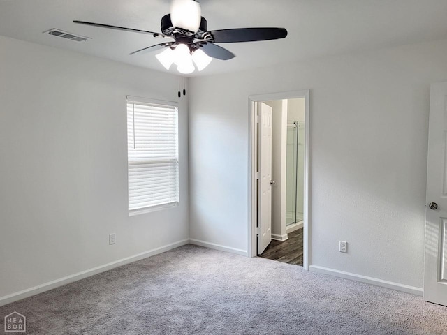 4909 Prospector Dr, Jonesboro, AR 72405 - unfurnished bedroom with carpet floors, ceiling fan, and connected bathroom