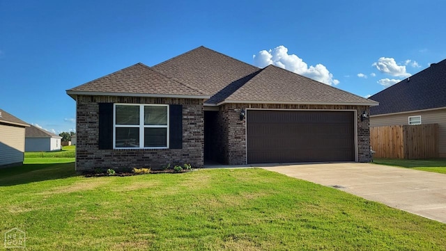 4909 Prospector Dr, Jonesboro, AR 72405 - view of front facade featuring a garage, concrete driveway, brick siding, and a shingled roof