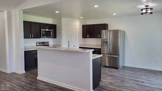 4909 Prospector Dr, Jonesboro, AR 72405 - kitchen with stainless steel appliances, dark wood finished floors, light countertops, a center island, and recessed lighting