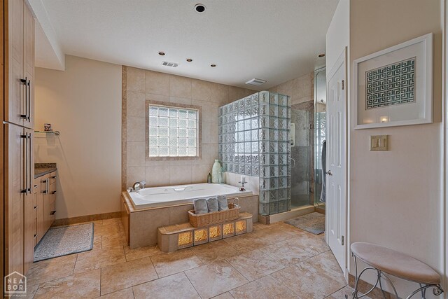 15 Plantation Oaks Ln, Jonesboro, AR 72401 - bathroom featuring a garden tub, a stall shower, vanity, recessed lighting, and baseboards