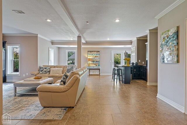 15 Plantation Oaks Ln, Jonesboro, AR 72401 - living area with a textured ceiling, baseboards, plenty of natural light, light tile patterned floors, and ornamental molding