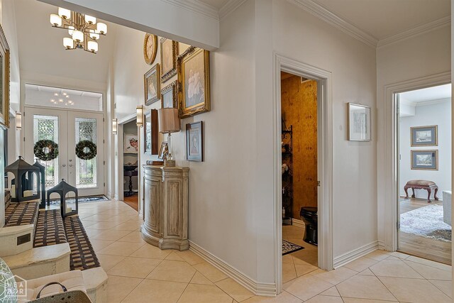 15 Plantation Oaks Ln, Jonesboro, AR 72401 - entrance foyer with light tile patterned floors, a chandelier, crown molding, baseboards, and french doors