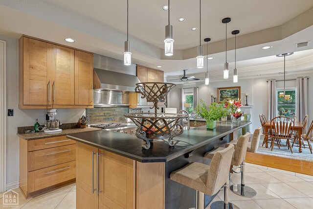 15 Plantation Oaks Ln, Jonesboro, AR 72401 - kitchen featuring light tile patterned floors, tasteful backsplash, recessed lighting, a center island, and a tray ceiling