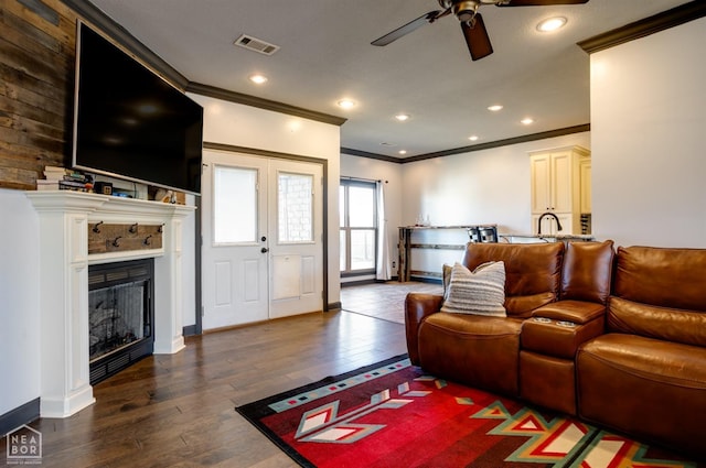 109 Harper Dr, Brookland, AR 72417 - living room with crown molding, ceiling fan, wood finished floors, a fireplace, and baseboards