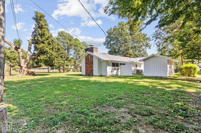 815 NW 3rd St, Walnut Ridge, AR 72476 - view of yard featuring an outbuilding, a storage unit, and central AC unit