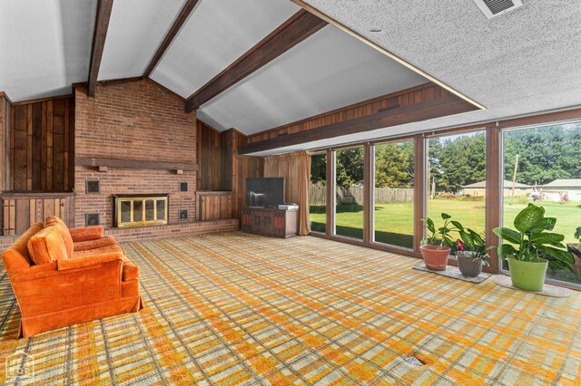 815 NW 3rd St, Walnut Ridge, AR 72476 - living area featuring wooden walls, a fireplace, vaulted ceiling with beams, and visible vents