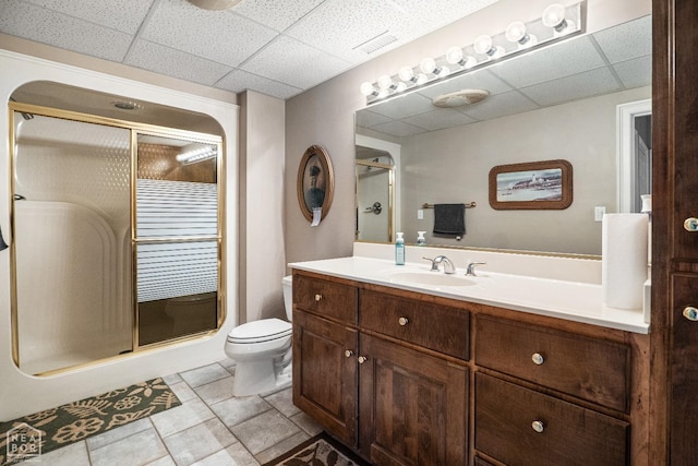 full bath featuring toilet, a stall shower, a paneled ceiling, and visible vents