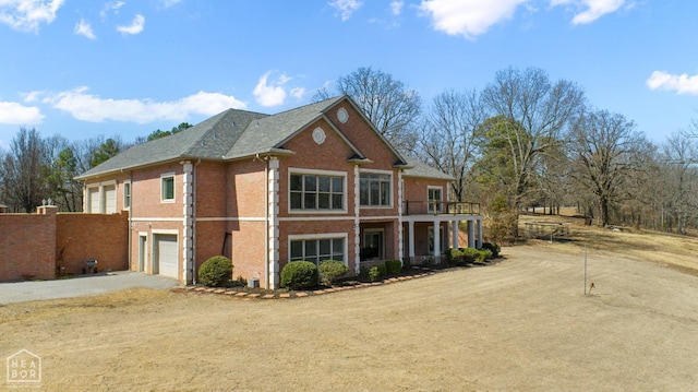 view of front of property with brick siding, driveway, and an attached garage