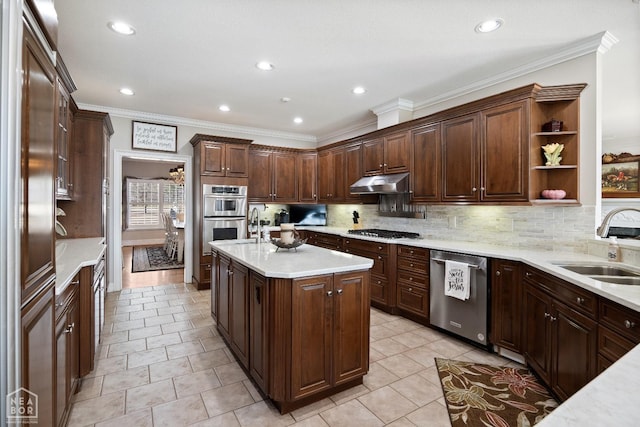 kitchen featuring tasteful backsplash, a sink, light countertops, under cabinet range hood, and stainless steel appliances