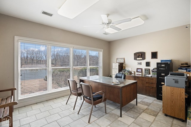 office space featuring a ceiling fan and visible vents