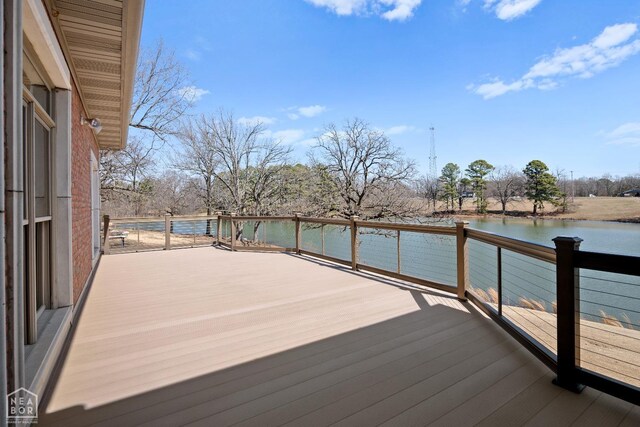 wooden terrace featuring a water view