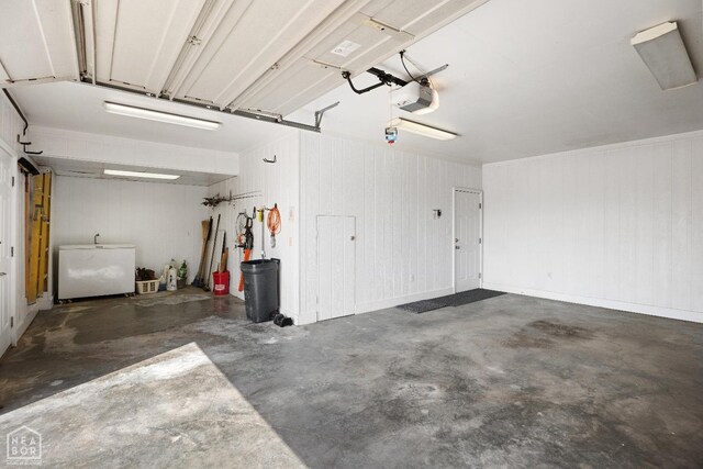 295 County Road 118, Bono, AR 72416 - garage with refrigerator and a garage door opener
