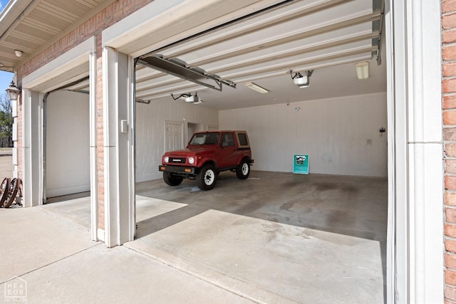 garage featuring a garage door opener and concrete driveway