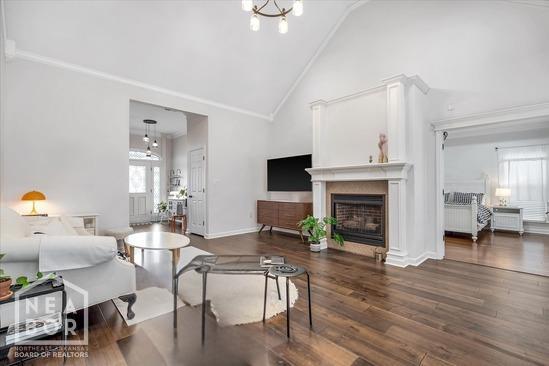 4024 Chapel Hill Dr, Jonesboro, AR 72404 - living area with a fireplace, high vaulted ceiling, wood finished floors, and baseboards