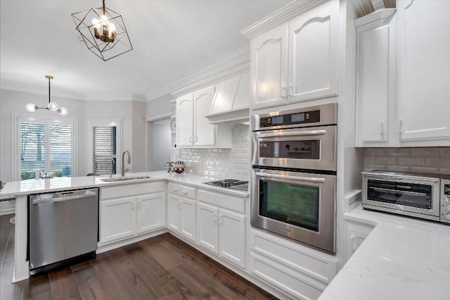 4024 Chapel Hill Dr, Jonesboro, AR 72404 - kitchen with appliances with stainless steel finishes, a sink, a chandelier, white cabinetry, and decorative light fixtures