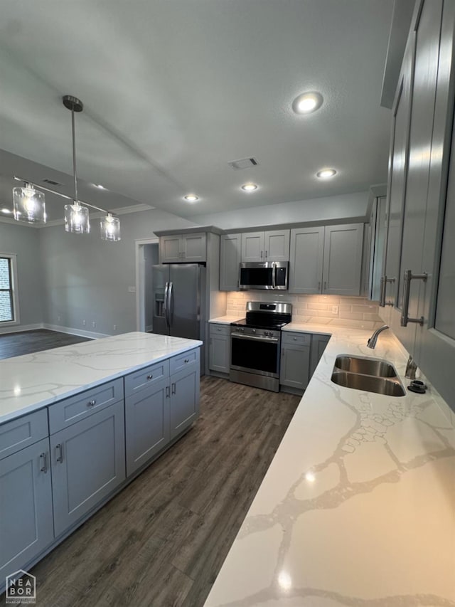 210 E College St, Bono, AR 72416 - kitchen with stainless steel appliances, a sink, gray cabinetry, dark wood-style flooring, and light stone countertops