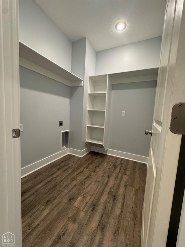 210 E College St, Bono, AR 72416 - laundry area with hookup for an electric dryer, dark wood-style floors, and baseboards