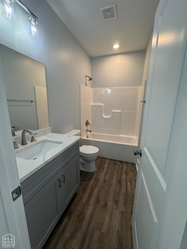 210 E College St, Bono, AR 72416 - full bathroom with wood finished floors,  shower combination, vanity, toilet, and recessed lighting