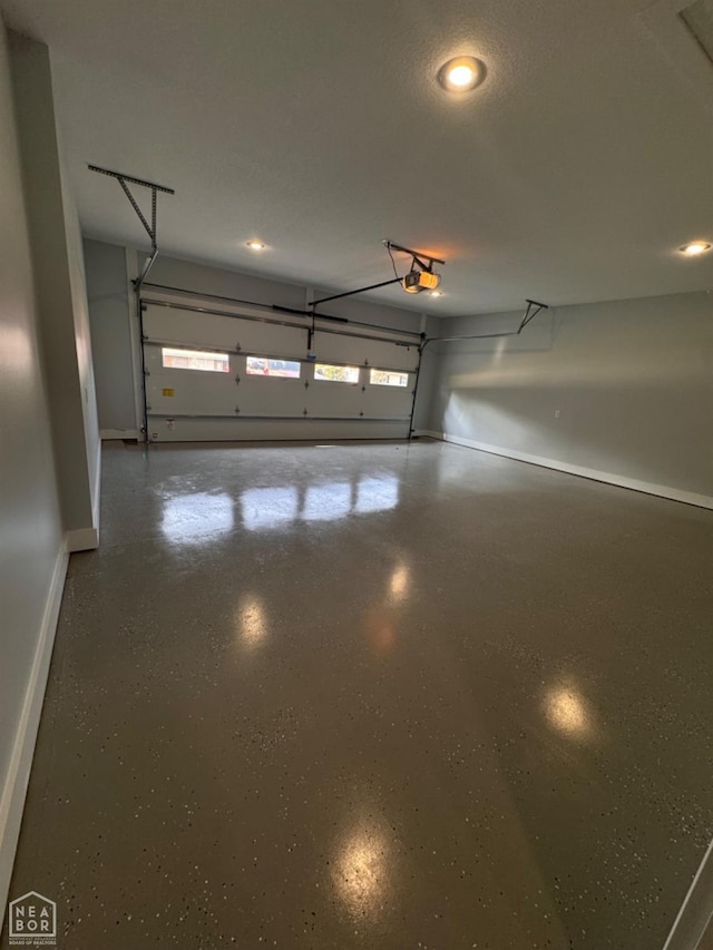 210 E College St, Bono, AR 72416 - garage with baseboards, recessed lighting, and a garage door opener