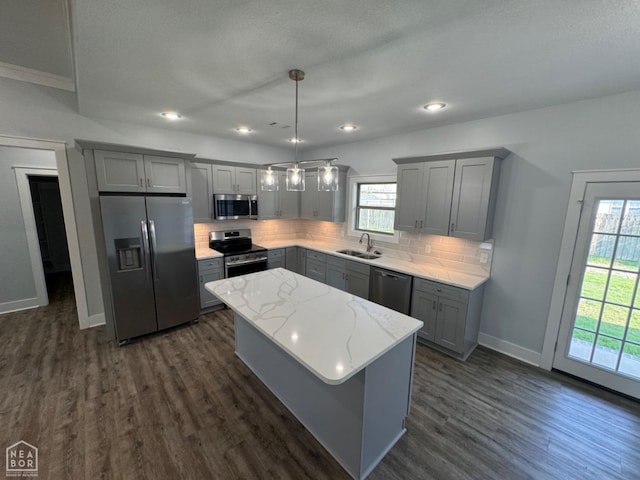 210 E College St, Bono, AR 72416 - kitchen with appliances with stainless steel finishes, gray cabinetry, a sink, dark wood-type flooring, and tasteful backsplash