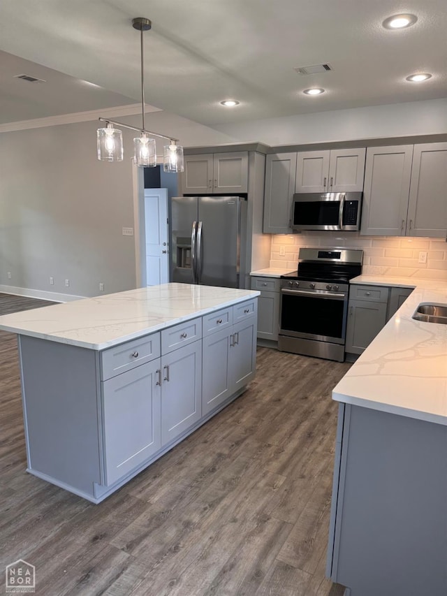 210 E College St, Bono, AR 72416 - kitchen featuring appliances with stainless steel finishes, gray cabinets, decorative backsplash, light stone counters, and ornamental molding