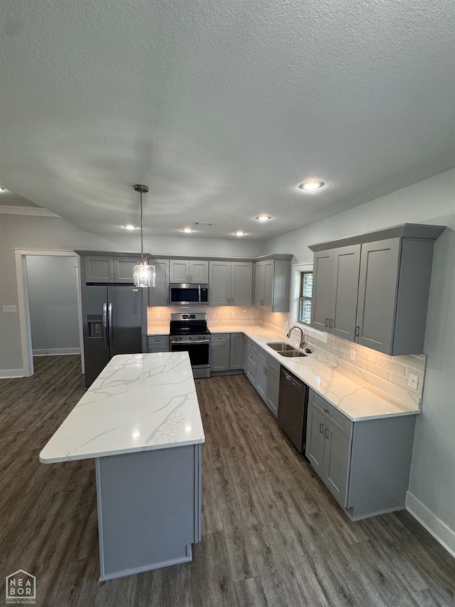 210 E College St, Bono, AR 72416 - kitchen with gray cabinetry, stainless steel appliances, a sink, a center island, and a textured ceiling