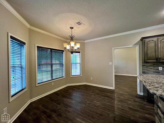 4112 Stephanie Ln, Jonesboro, AR 72405 - unfurnished dining area featuring a textured ceiling, a chandelier, dark wood finished floors, ornamental molding, and baseboards