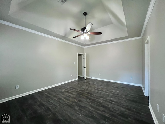 4112 Stephanie Ln, Jonesboro, AR 72405 - empty room featuring a tray ceiling, ceiling fan, dark wood-style flooring, ornamental molding, and baseboards