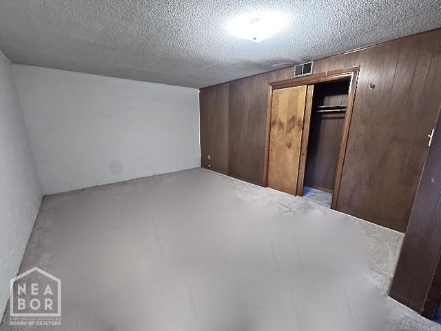 905 Locust Dr, Jonesboro, AR 72401 - finished below grade area with wooden walls and a textured ceiling
