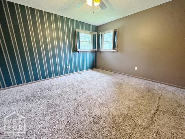 905 Locust Dr, Jonesboro, AR 72401 - carpeted empty room with ceiling fan, a textured ceiling, baseboards, and wallpapered walls
