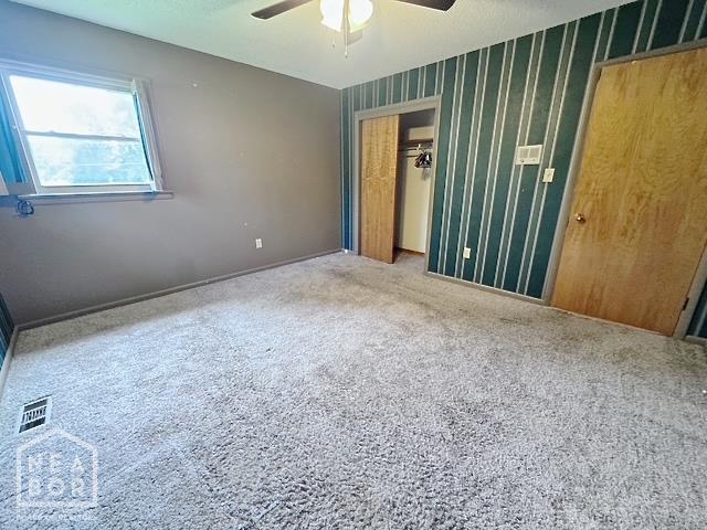 905 Locust Dr, Jonesboro, AR 72401 - unfurnished bedroom with a closet, carpet, a ceiling fan, and baseboards