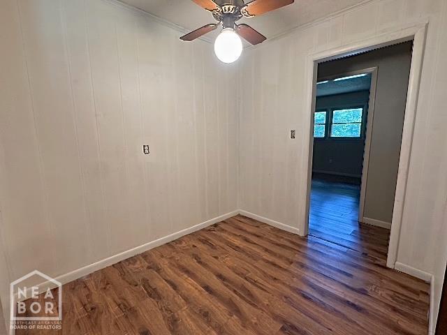 905 Locust Dr, Jonesboro, AR 72401 - spare room featuring dark wood finished floors, baseboards, ceiling fan, and ornamental molding