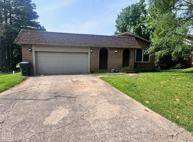 905 Locust Dr, Jonesboro, AR 72401 - view of front of home featuring brick siding, driveway, a front yard, mansard roof, and an attached garage