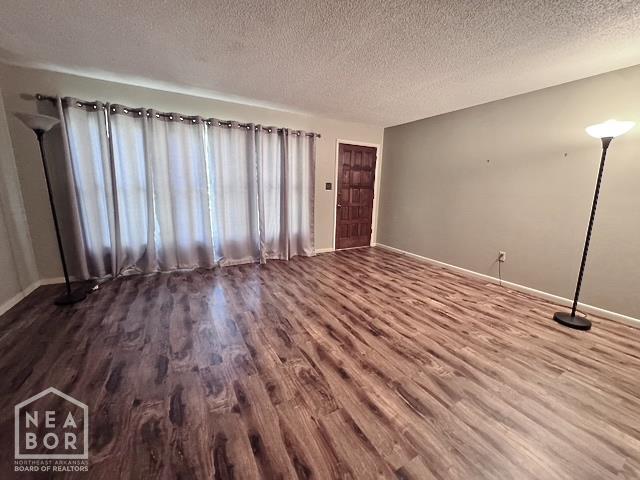 905 Locust Dr, Jonesboro, AR 72401 - spare room featuring wood finished floors, a textured ceiling, and baseboards
