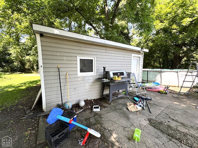 731 S Thornton Ave, Piggott, AR 72454 - view of patio with an outdoor pool, an outdoor structure, and view of scattered trees