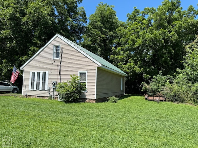 731 S Thornton Ave, Piggott, AR 72454 - view of property exterior featuring a lawn and crawl space