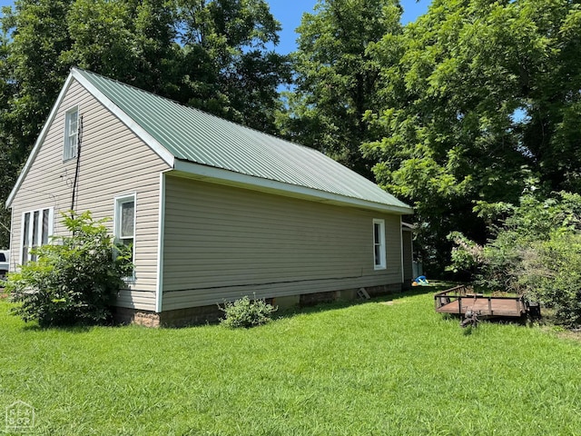 731 S Thornton Ave, Piggott, AR 72454 - view of property exterior with a lawn and a metal roof