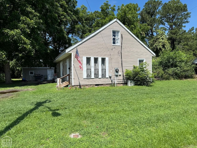 731 S Thornton Ave, Piggott, AR 72454 - rear view of house with crawl space and a lawn
